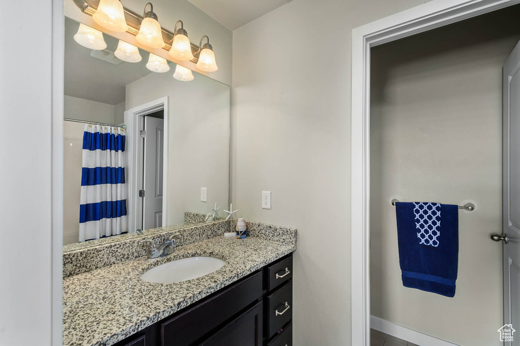 Full bath with vanity and curtained shower