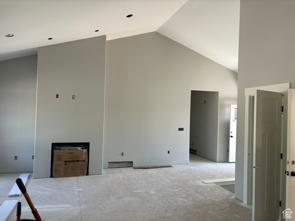 Unfurnished bedroom featuring high vaulted ceiling