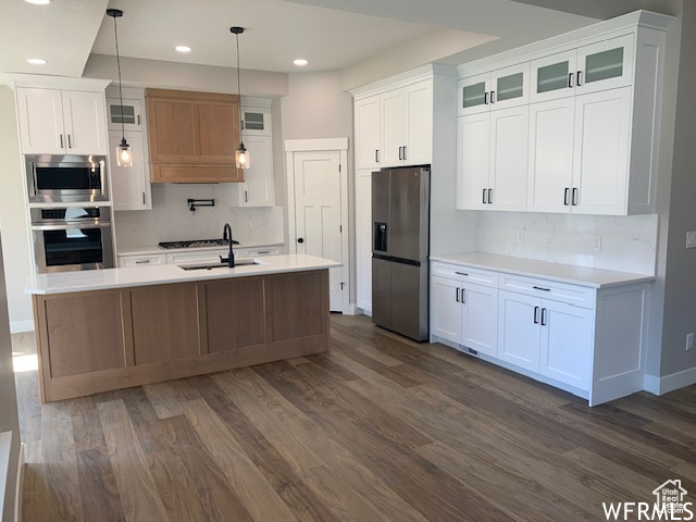 Kitchen with appliances with stainless steel finishes, dark wood-style flooring, recessed lighting, and light countertops