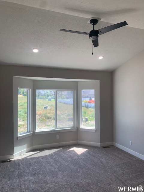 Empty room featuring baseboards, a textured ceiling, carpet flooring, ceiling fan, and recessed lighting