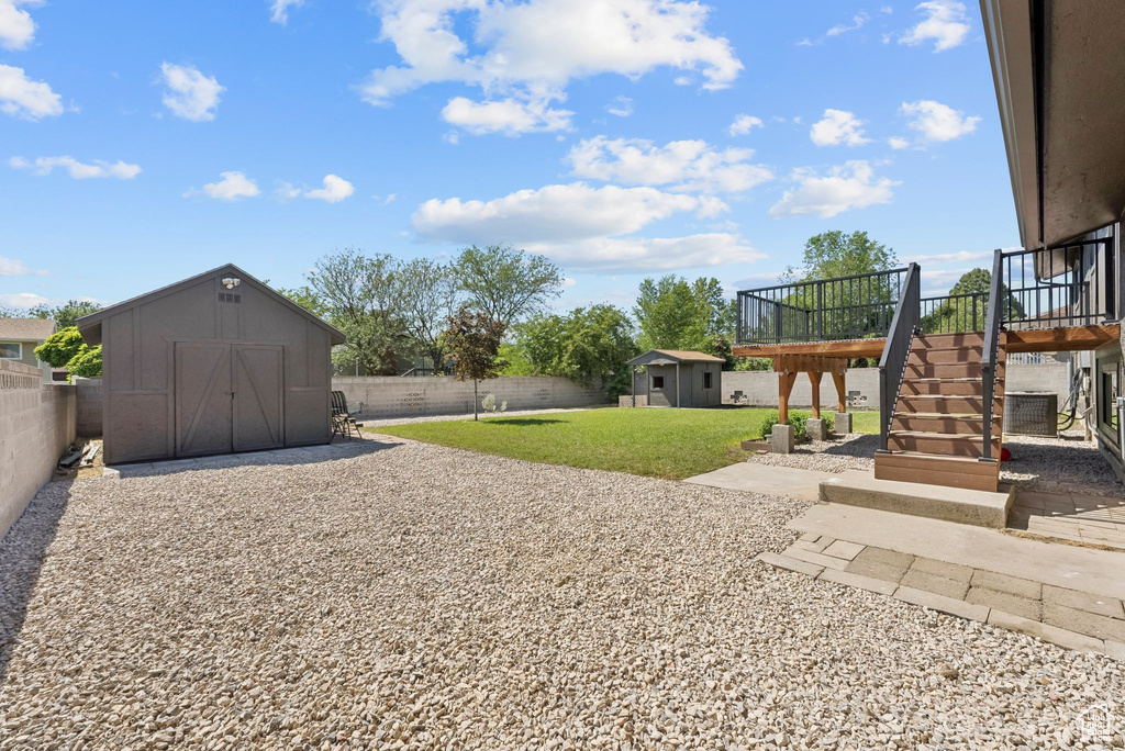 View of yard with stairs and a wooden deck