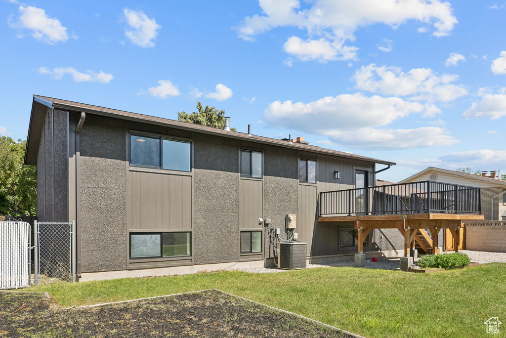 Back of house with a deck, stairway, and central air condition unit