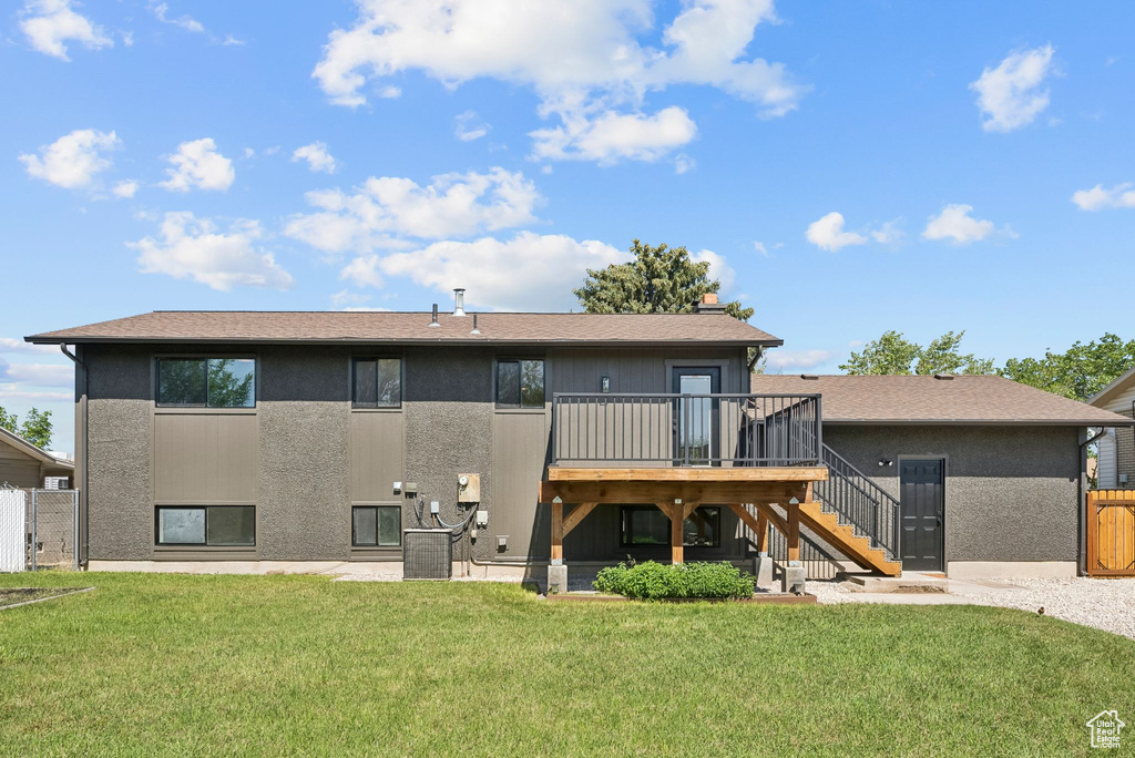 Back of house featuring stairs, a deck, central AC, a chimney, and a patio