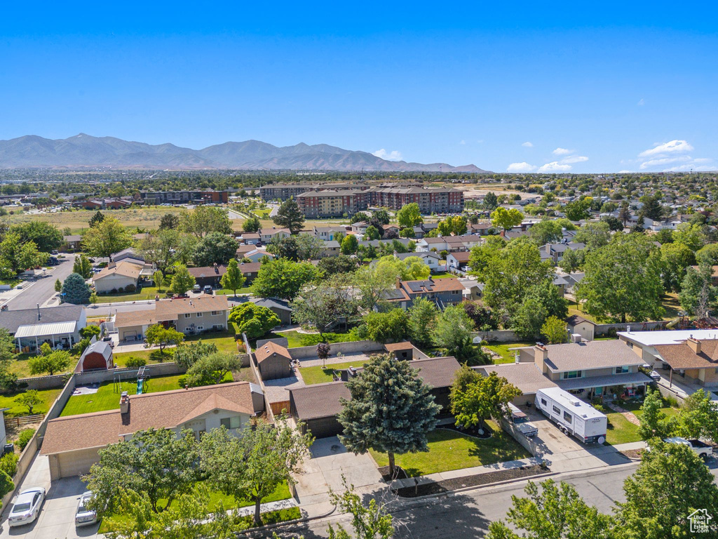 Aerial view of residential area featuring a mountainous background