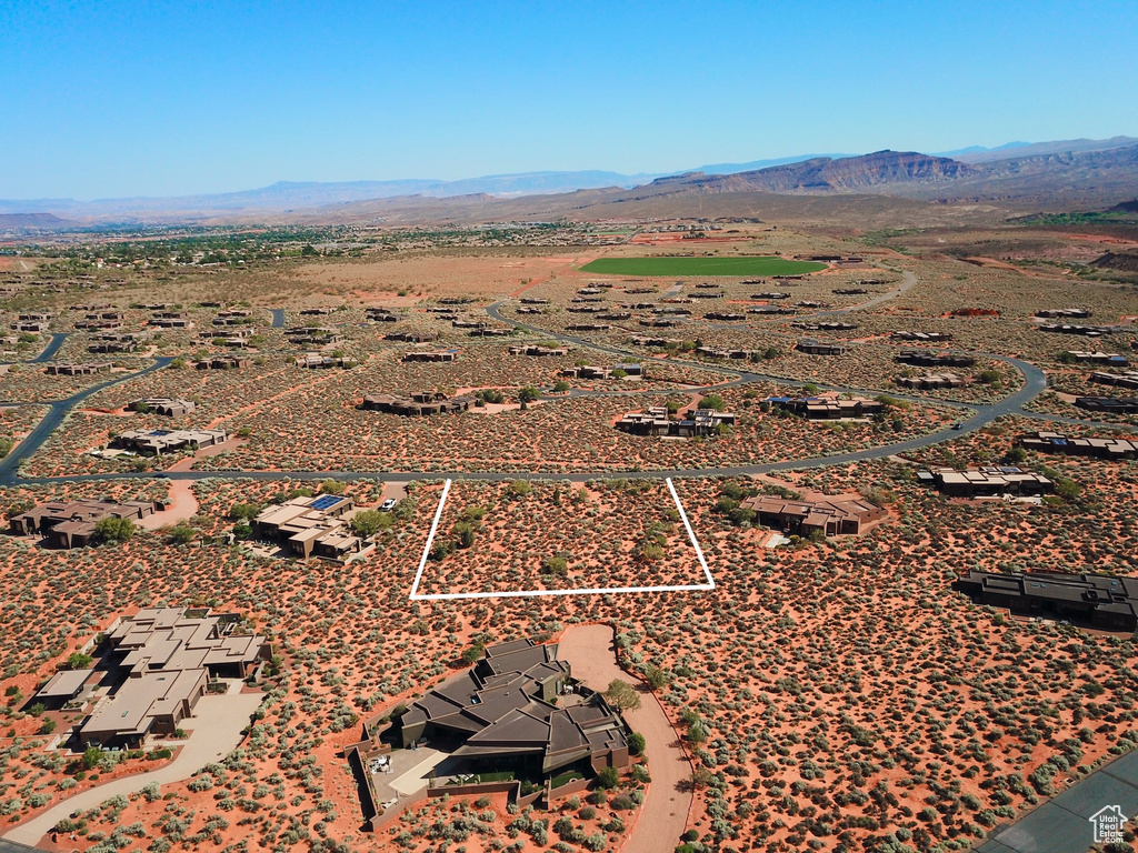 Aerial view of property's location featuring a mountainous background, property boundaries highlighted, and a desert landscape
