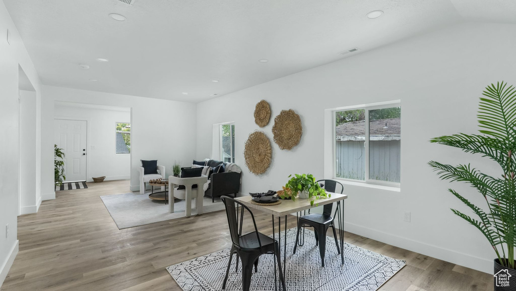 Dining room featuring plenty of natural light, baseboards, recessed lighting, and light wood finished floors