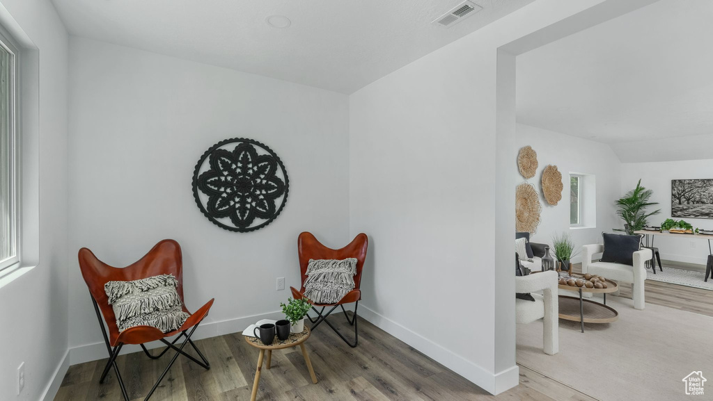 Living area with wood finished floors and baseboards