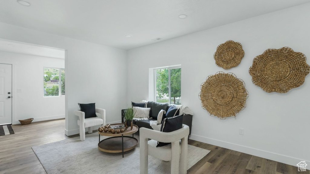 Living area with baseboards, wood finished floors, and recessed lighting