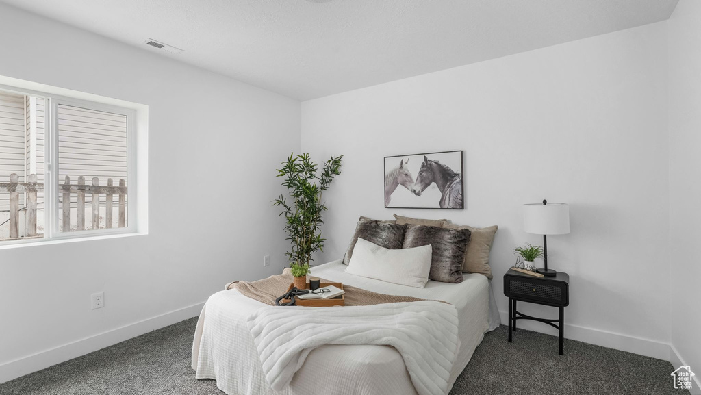 Bedroom with carpet floors and baseboards