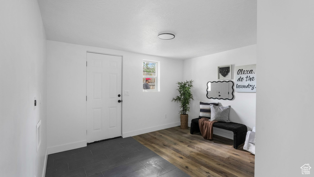 Entryway with baseboards and dark wood-style floors