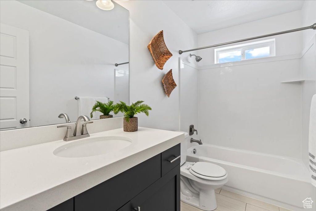 Full bathroom featuring  shower combination, vanity, and toilet