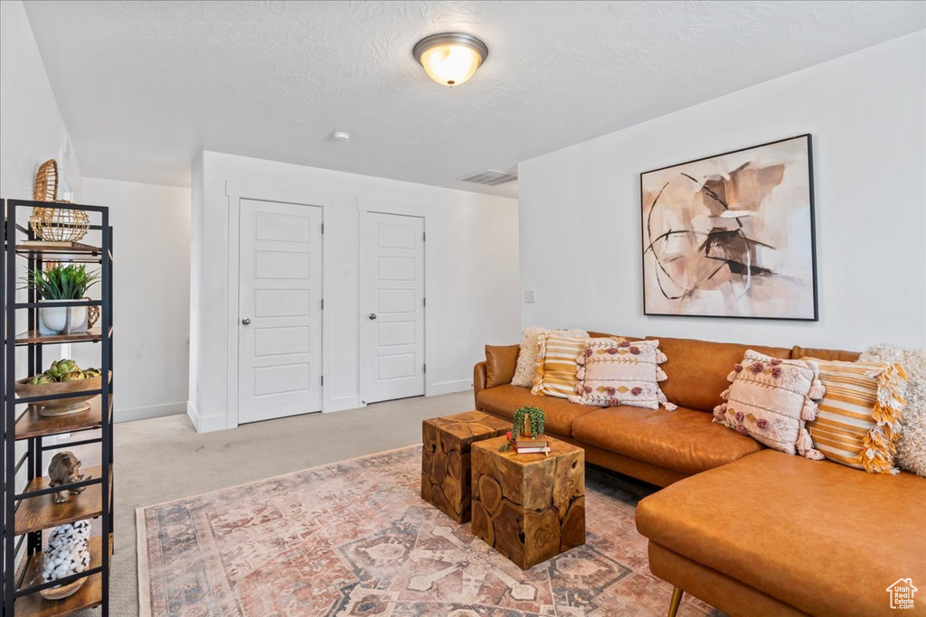 Carpeted living area featuring baseboards