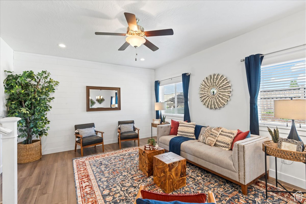 Living room featuring wood finished floors, ceiling fan, and recessed lighting