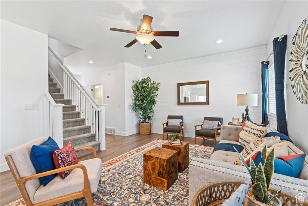Living area featuring ceiling fan, wood finished floors, stairway, recessed lighting, and baseboards