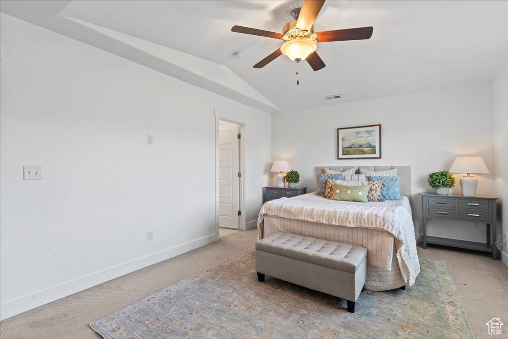 Bedroom with light carpet, baseboards, lofted ceiling, and a ceiling fan