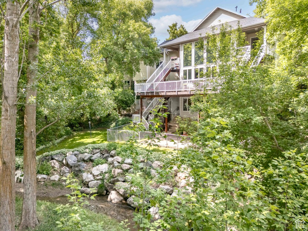 View of yard featuring stairway and a wooden deck