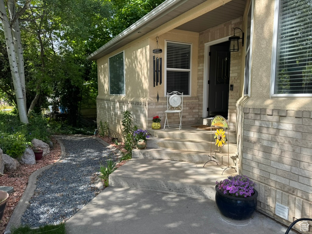 Entrance to property featuring brick siding