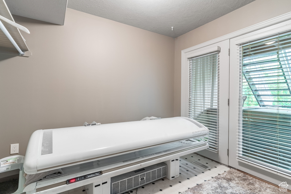 Miscellaneous room featuring a textured ceiling