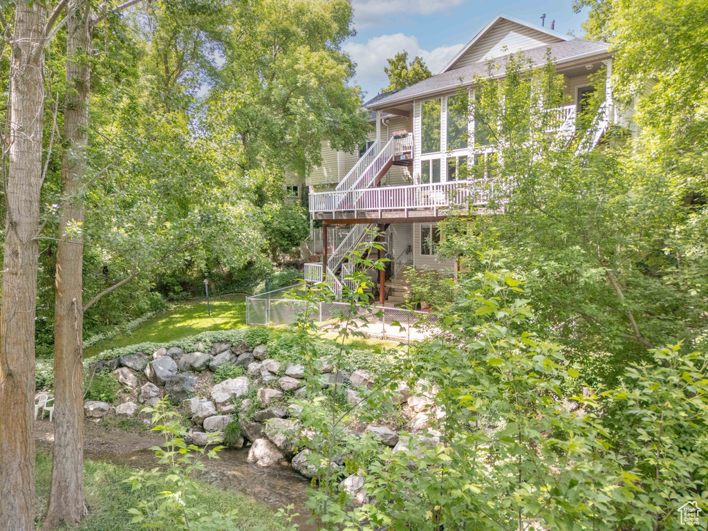 View of yard with stairway and a deck