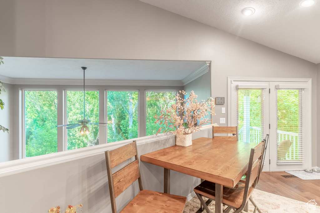 Dining space with vaulted ceiling, light wood-type flooring, ornamental molding, and recessed lighting