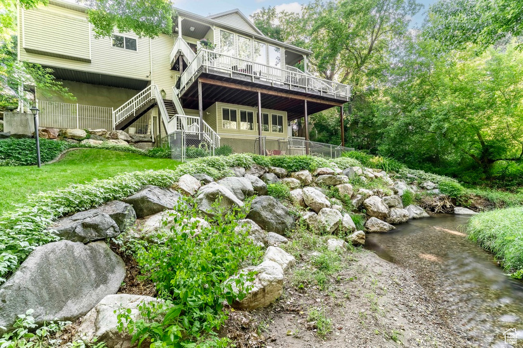 Rear view of property featuring a deck and stairway