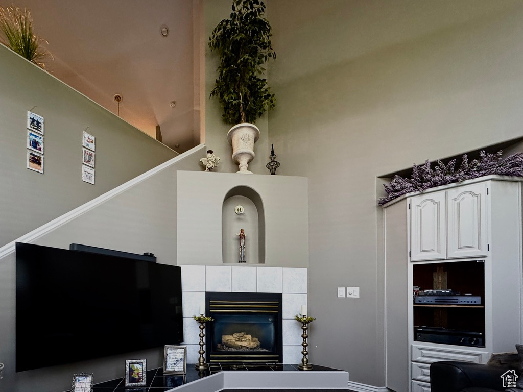 Living area with a tile fireplace and baseboards