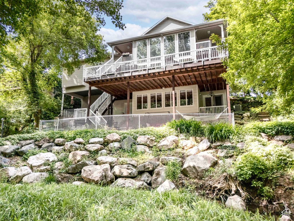 Rear view of property featuring a deck and stairway
