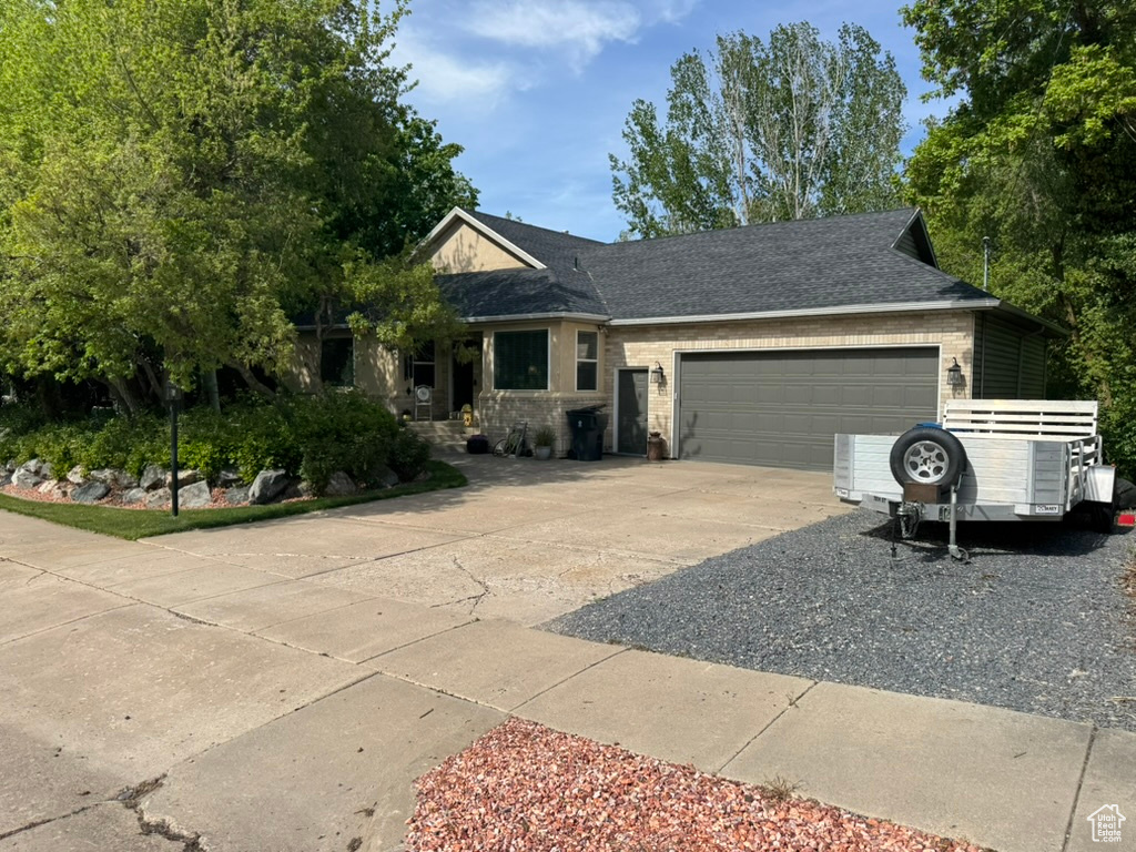 Ranch-style home with concrete driveway and an attached garage