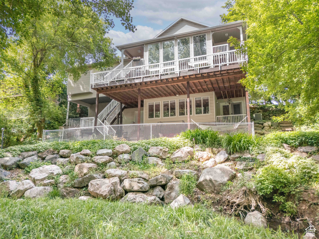 Back of property featuring a deck and stairway
