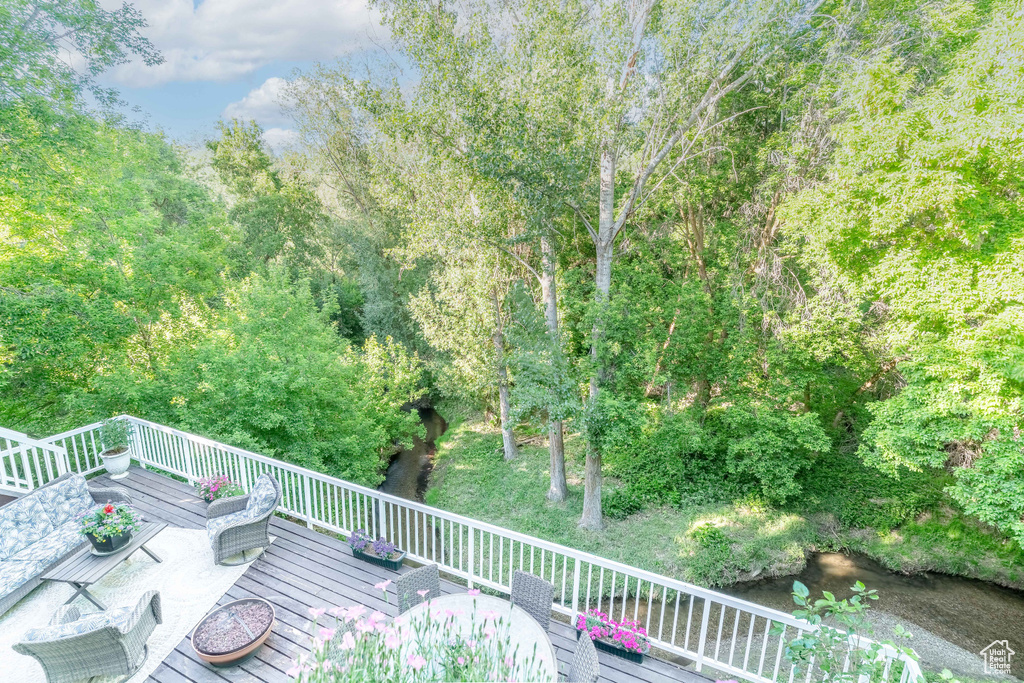 Wooden terrace featuring a view of trees