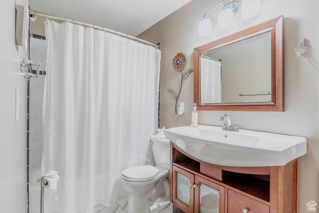 Full bathroom featuring vanity and curtained shower