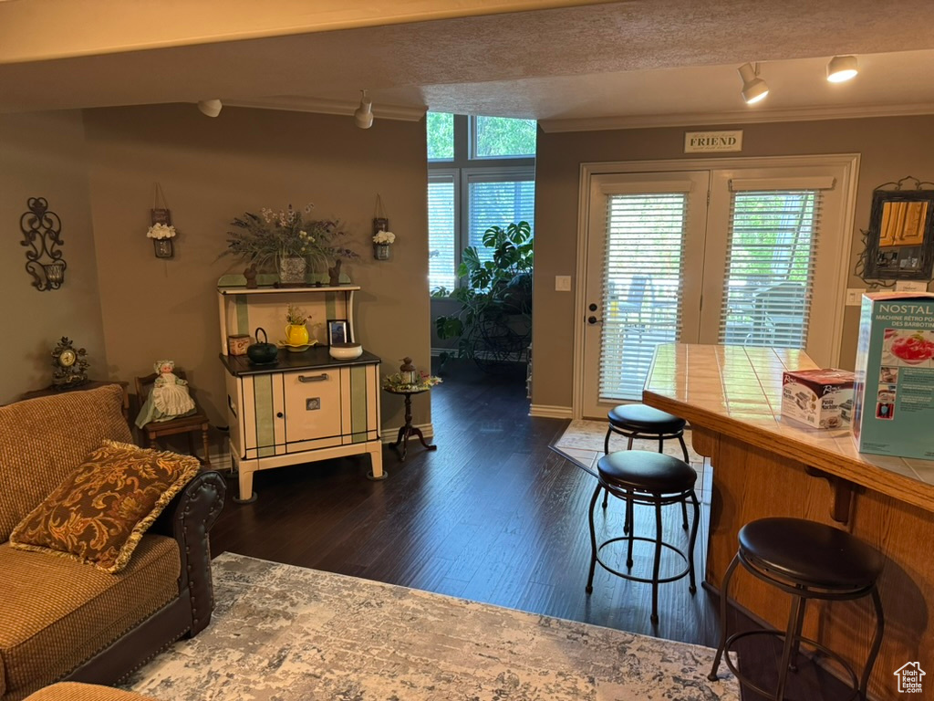 Dining room featuring ornamental molding and dark wood finished floors