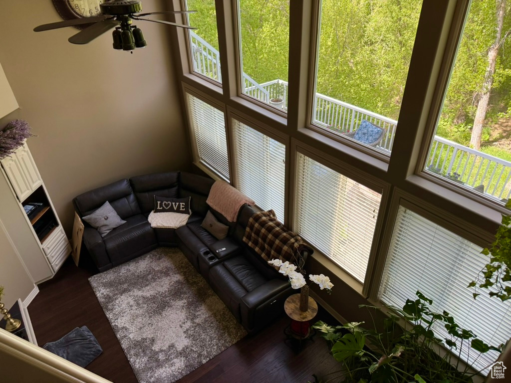 Living room with dark wood-style flooring and ceiling fan