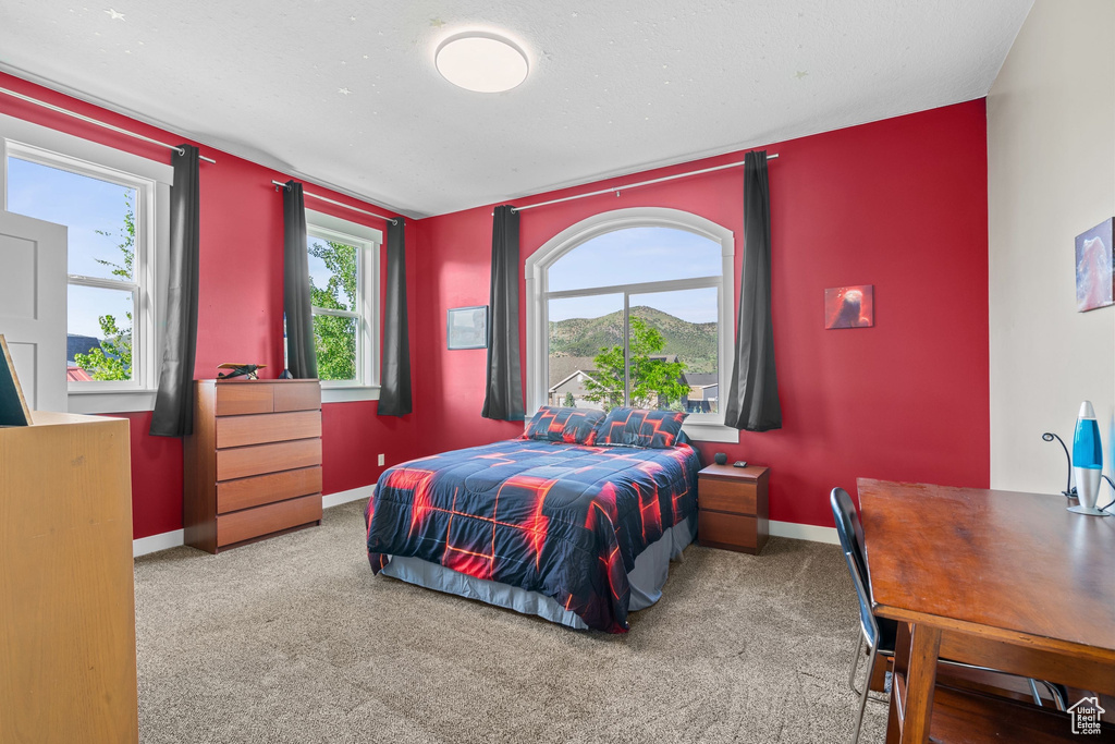 Bedroom featuring carpet flooring and baseboards