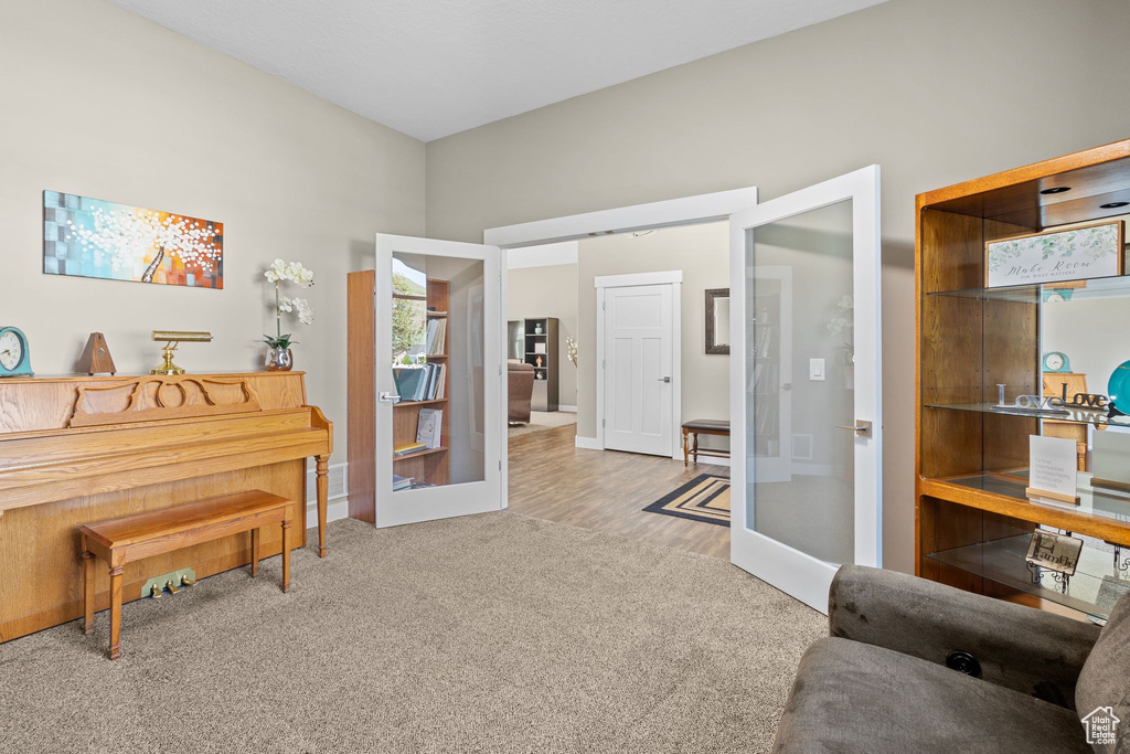 Sitting room featuring carpet floors and french doors