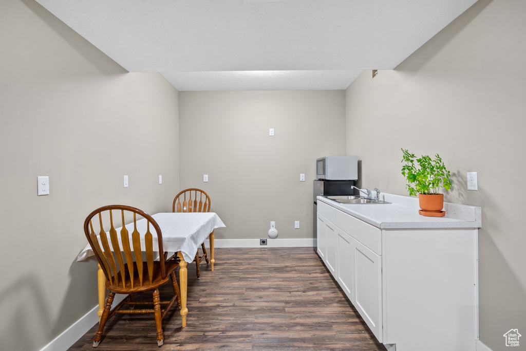 Dining area with dark wood finished floors and baseboards
