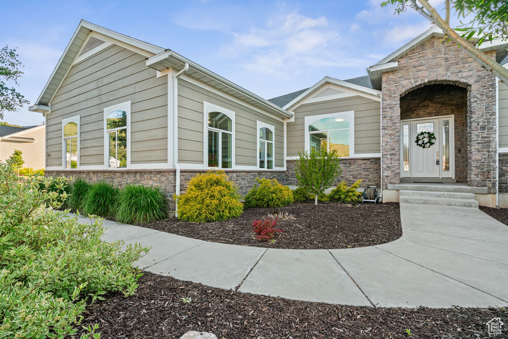 View of front facade featuring stone siding