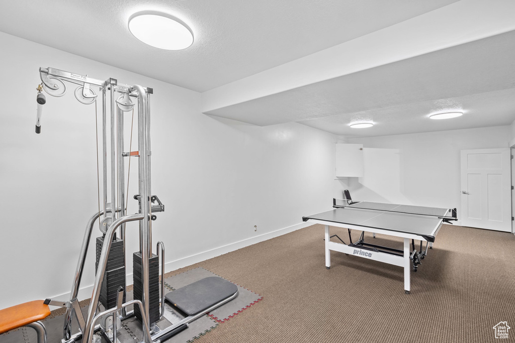Workout area featuring carpet floors and baseboards