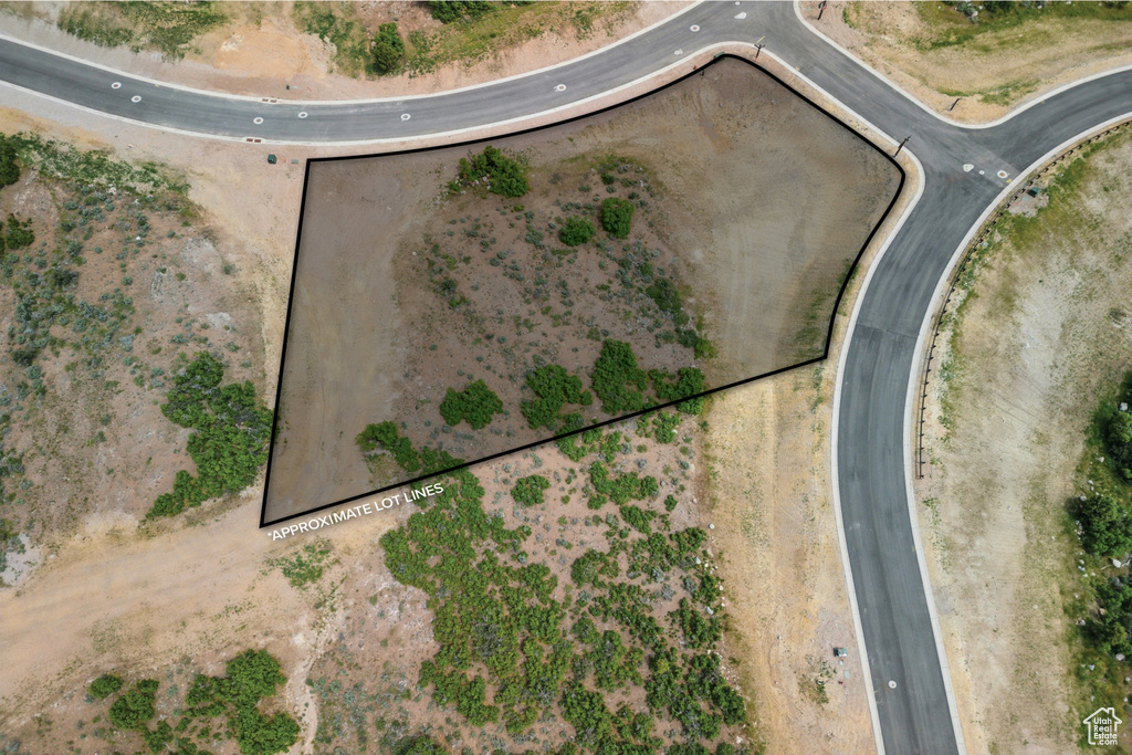 Aerial view of property and surrounding area featuring property parcel outlined