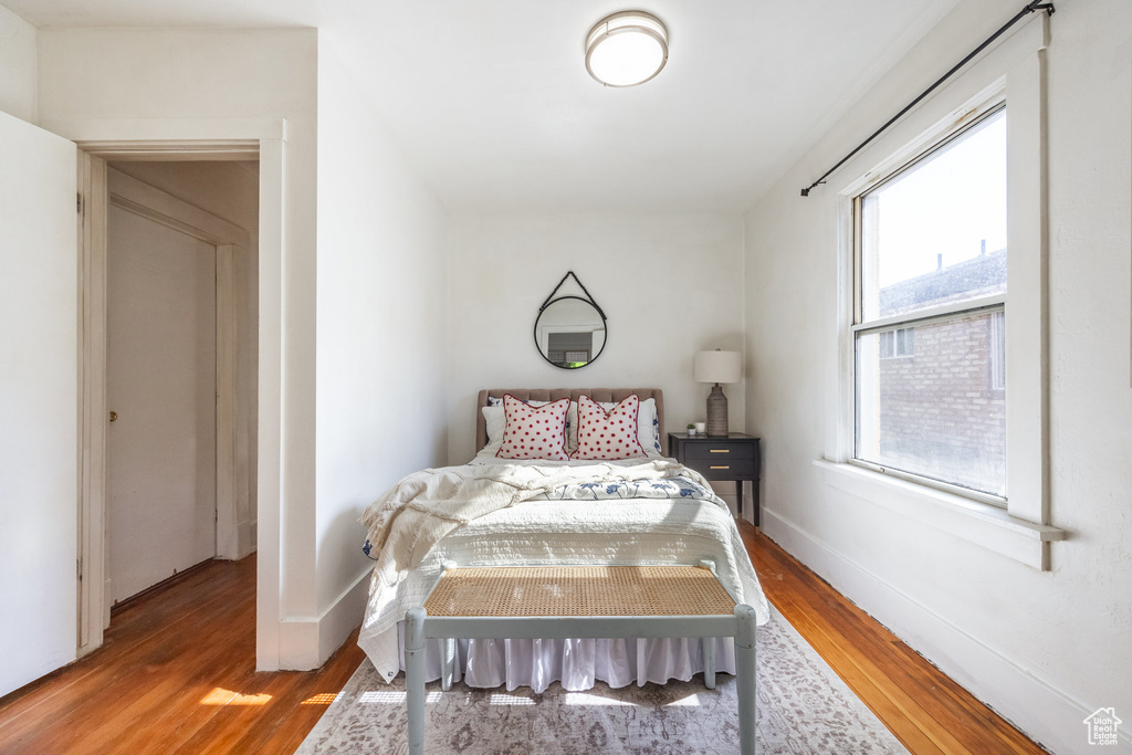 Bedroom featuring wood finished floors and baseboards