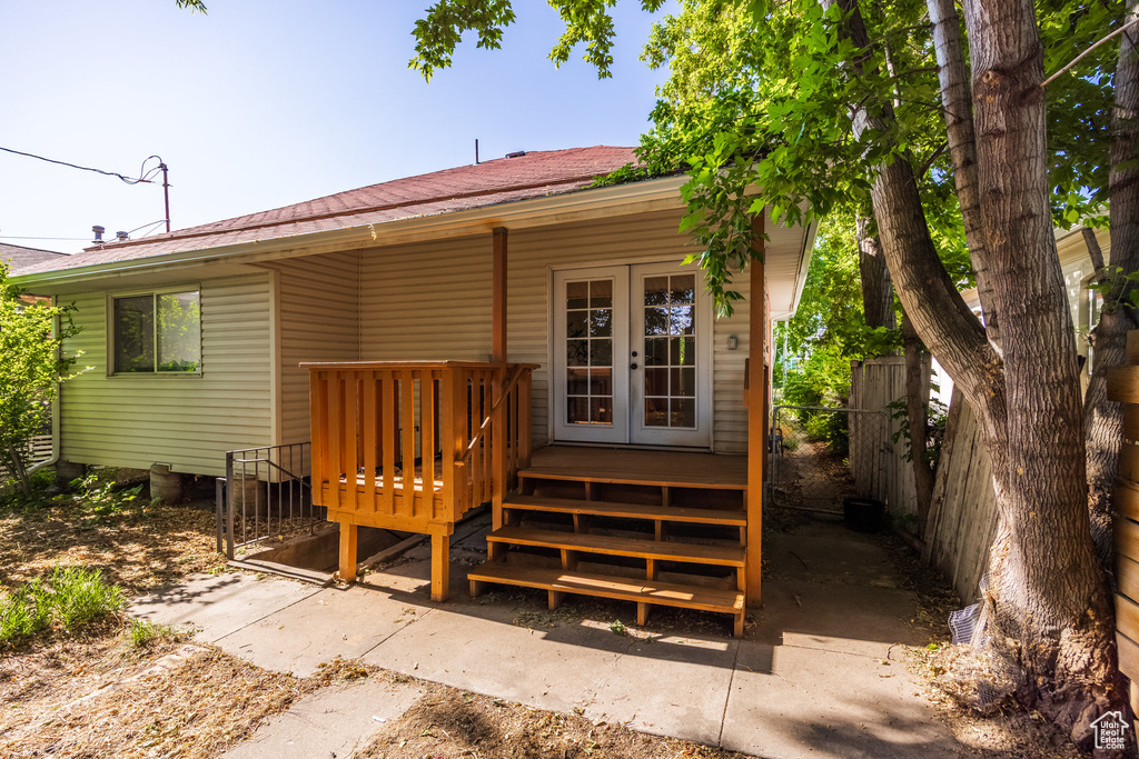 Rear view of property featuring a wooden deck and metal roof