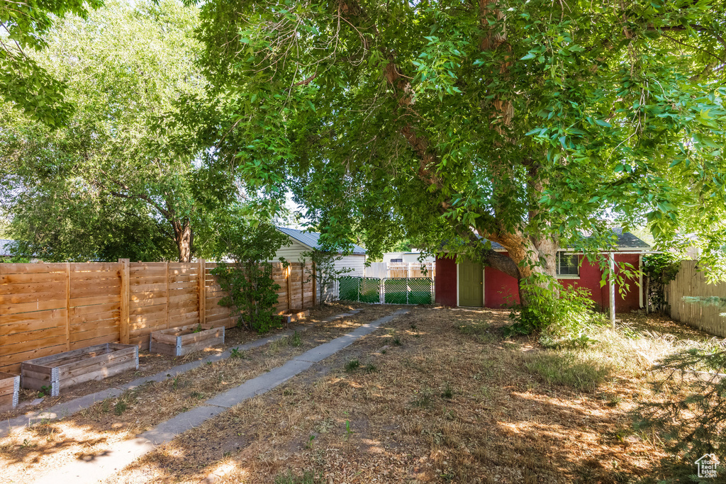 Fenced backyard with an outdoor structure