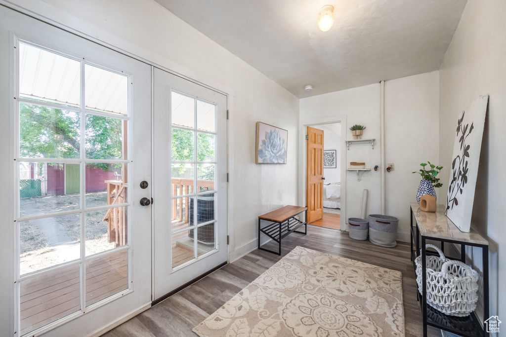 Entryway with french doors, wood finished floors, and baseboards