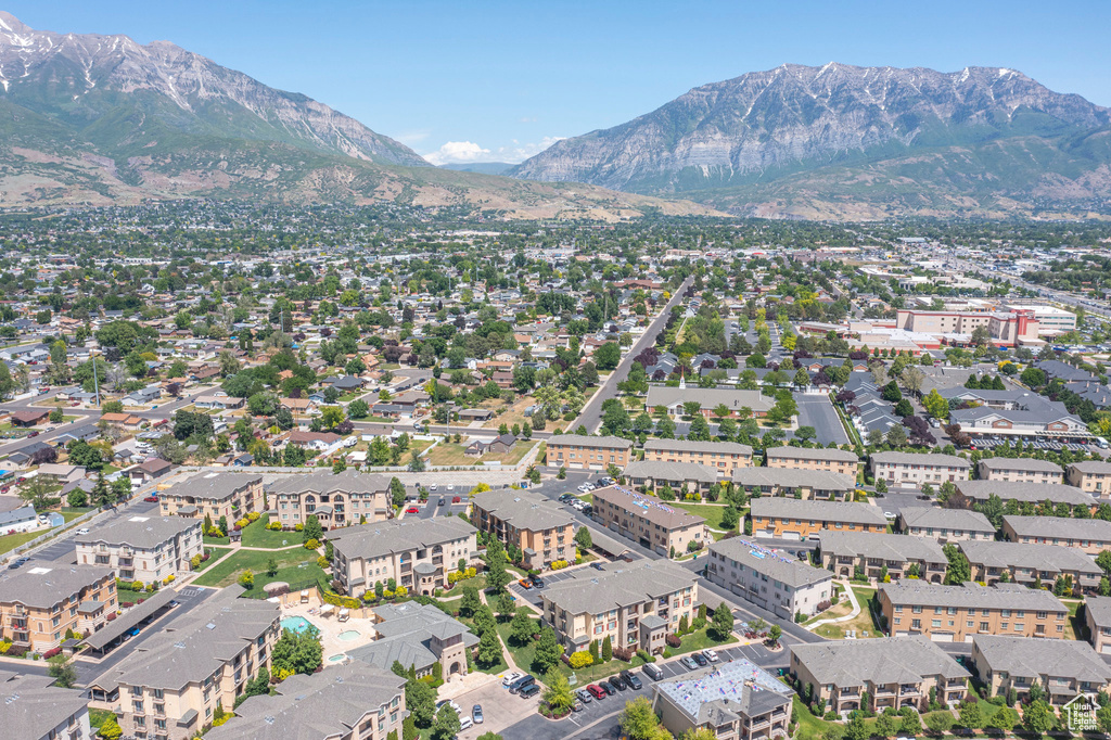 Aerial view of property and surrounding area featuring a mountainous background