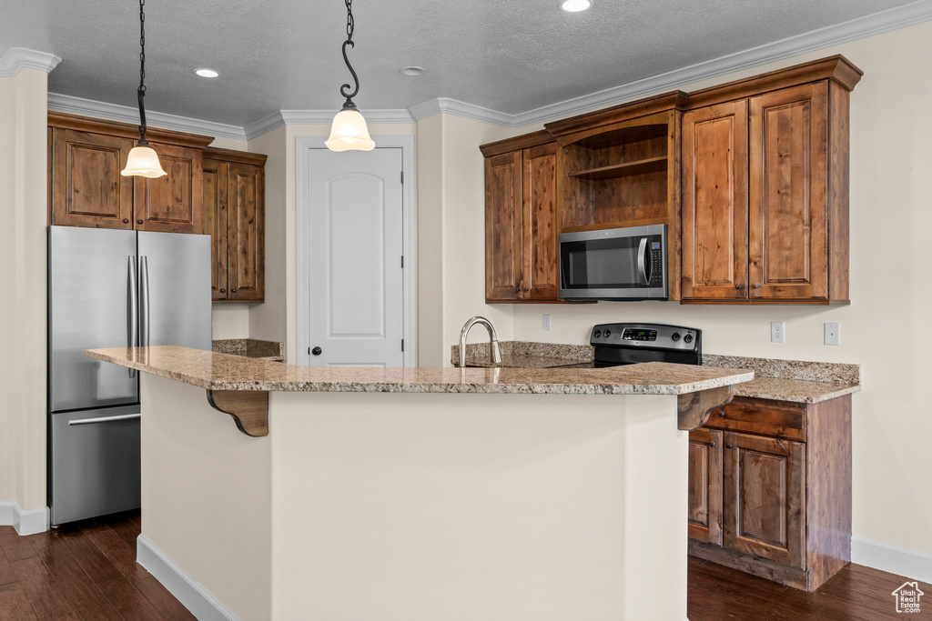 Kitchen with stainless steel appliances, open shelves, baseboards, dark wood-style flooring, and a kitchen island with sink