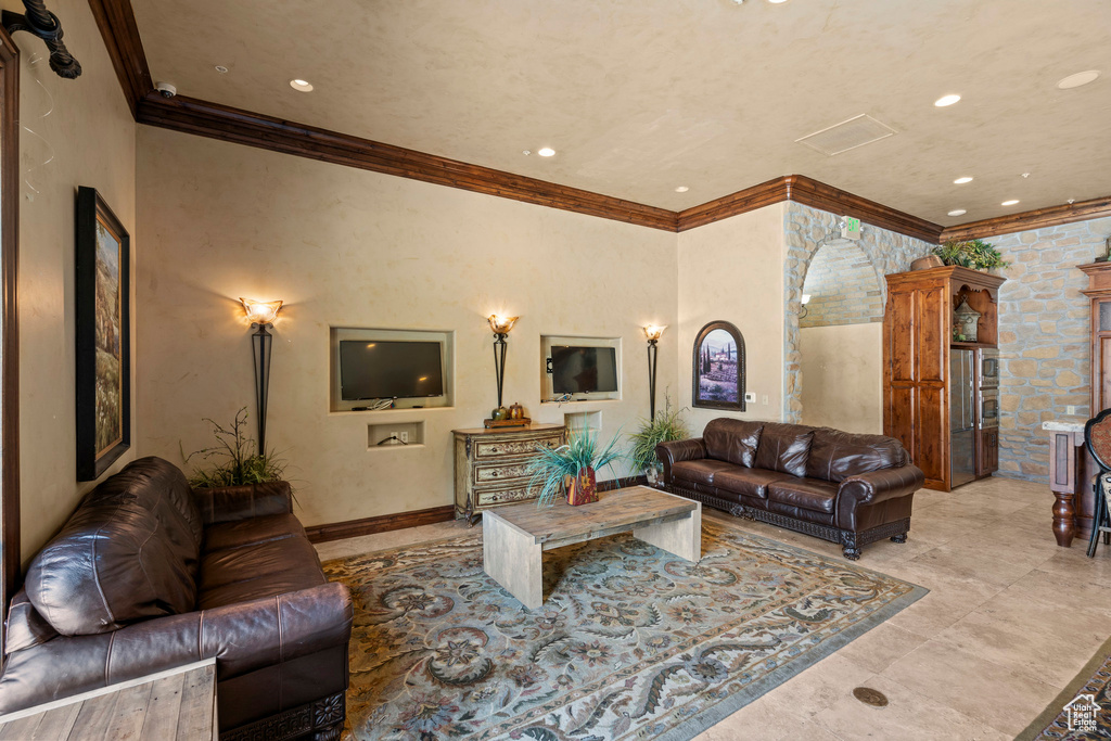 Living room with crown molding and recessed lighting