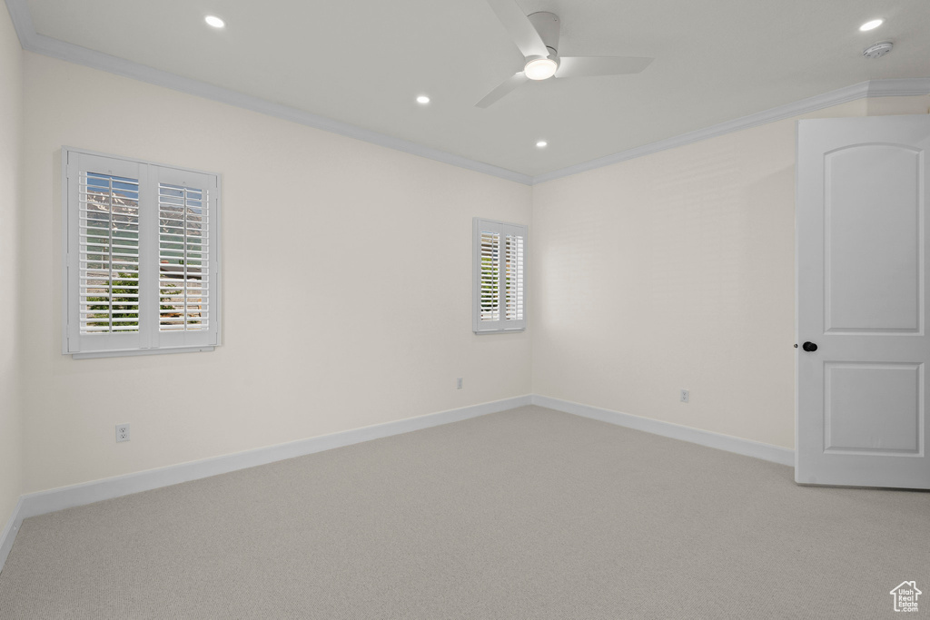 Unfurnished room featuring a ceiling fan, baseboards, light carpet, recessed lighting, and crown molding