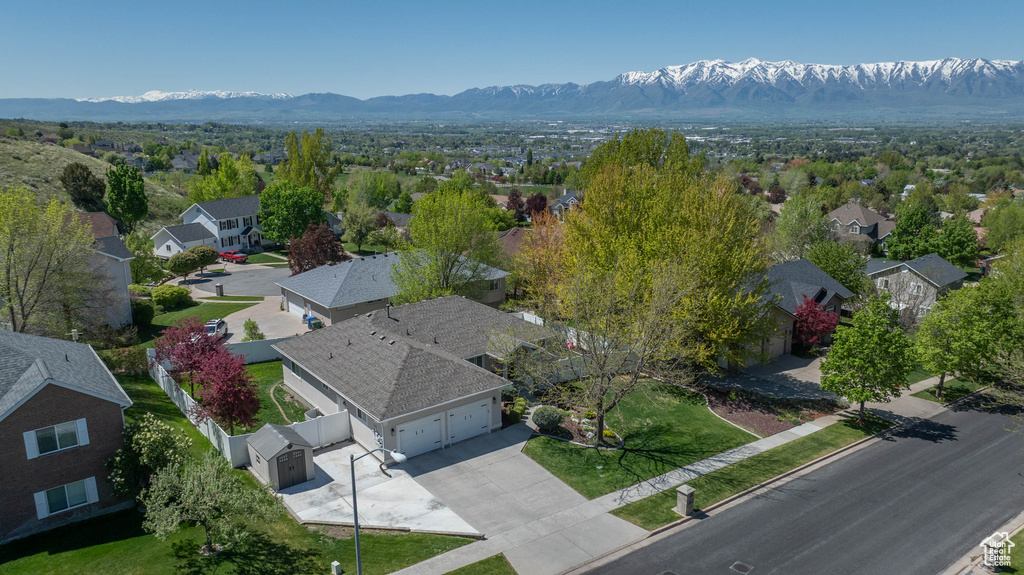 Aerial view of residential area featuring a mountainous background