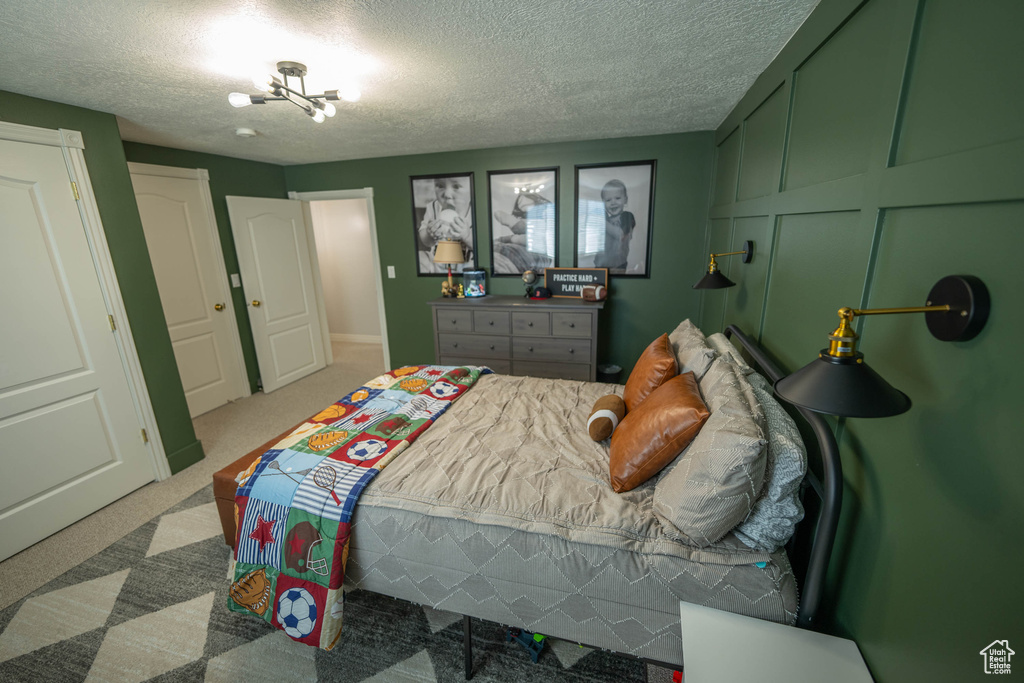 Bedroom featuring a textured ceiling and carpet floors