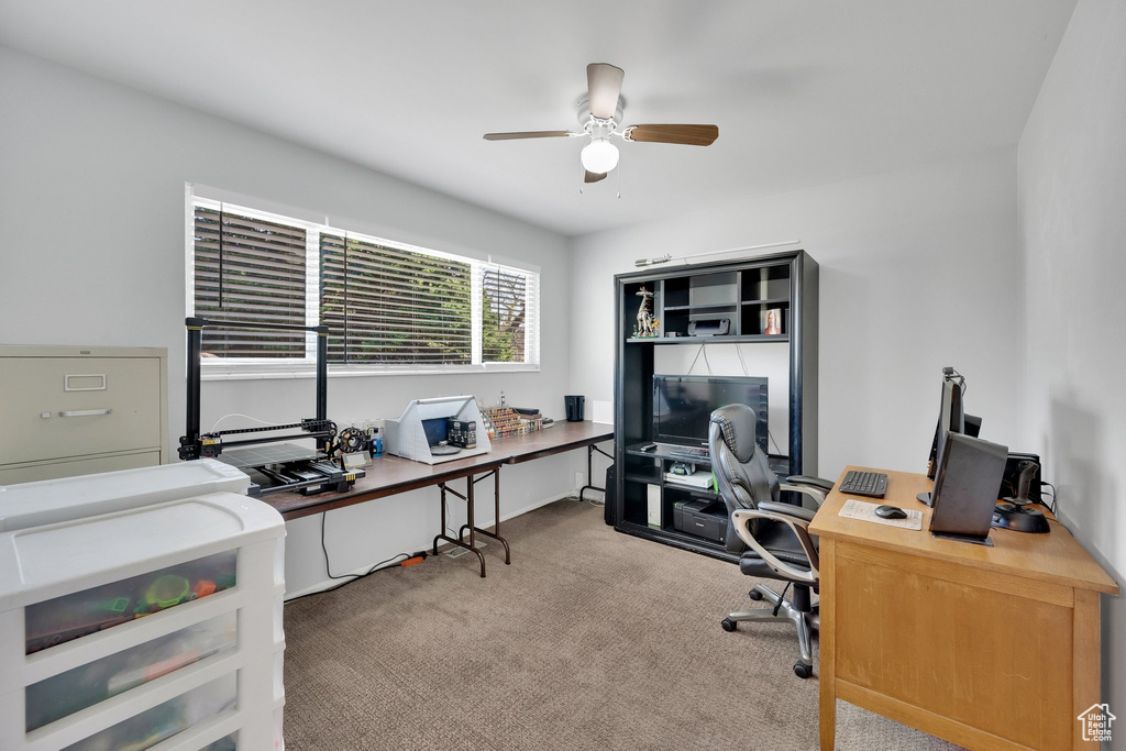 Office area featuring a ceiling fan and carpet floors